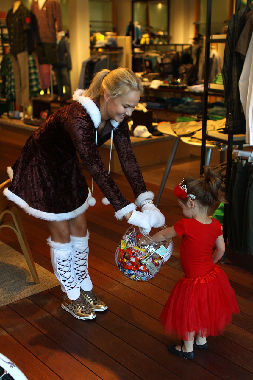 Molly Raff hands out candy to Lillian Beattie during St. Armand's Halloween.