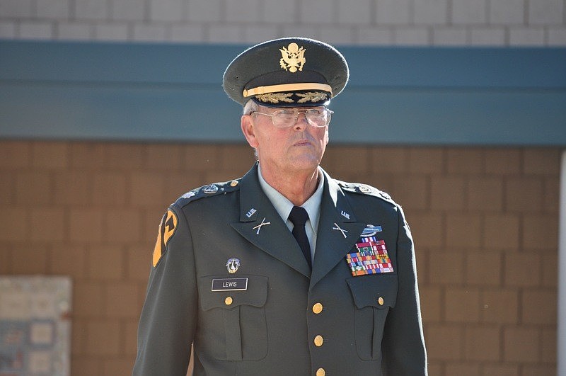 Col. Bob Lewis assisted with the flag-raising ceremony.