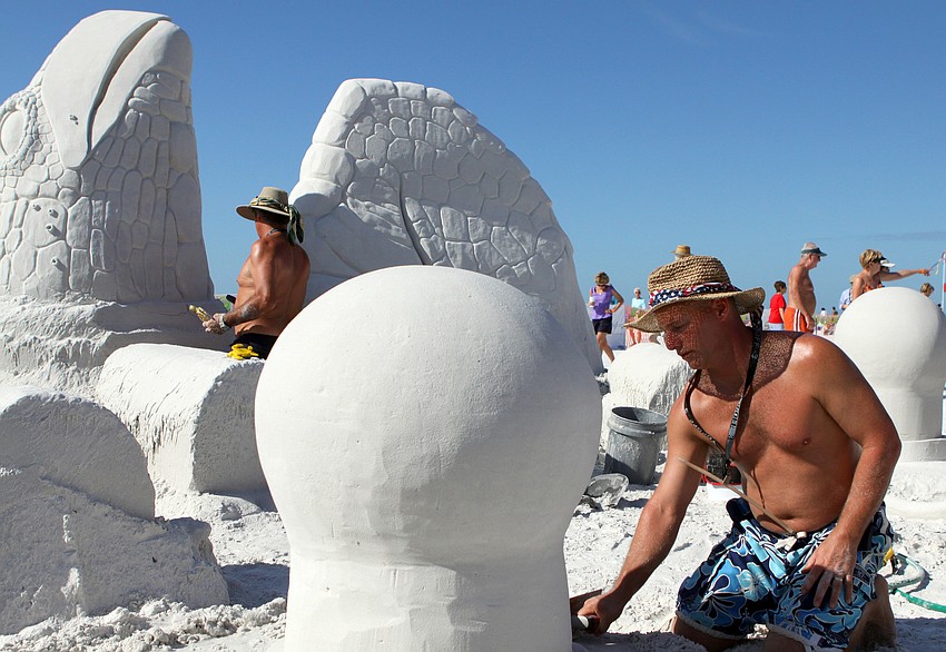 John Gowdy and Matt Deibert work on their sand sculpture during the Siesta Key Crystal Classic Master Sand Sculpting Competition.