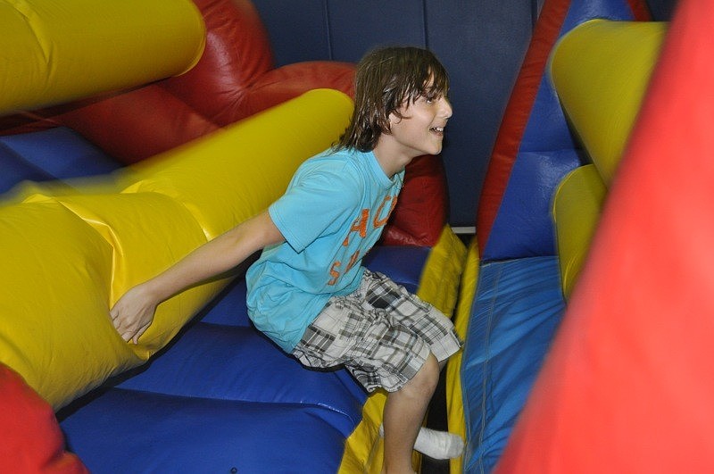 Larry Pino, 11, raced a friend in the inflatable obstacle course.