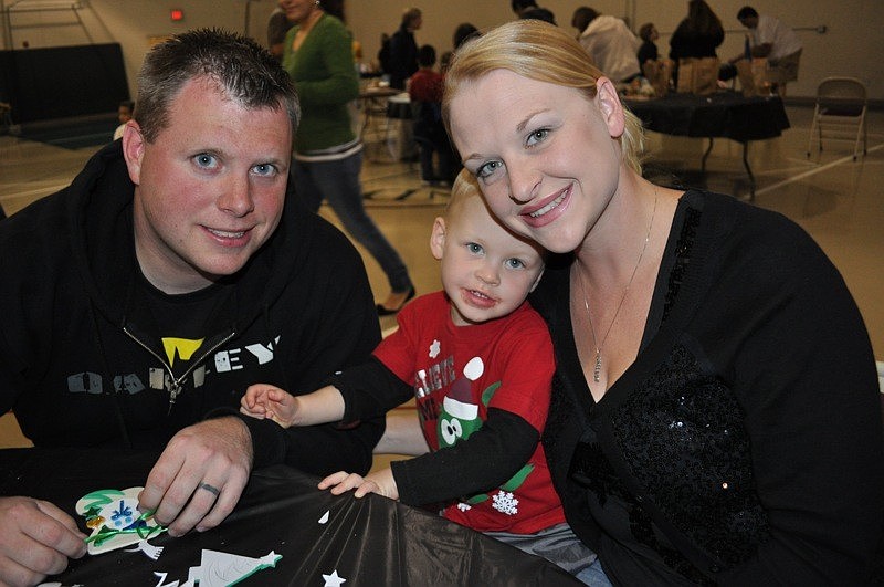 Elliott and Kristin Waller helped their 3-year-old son Caleb, center, make ornaments.