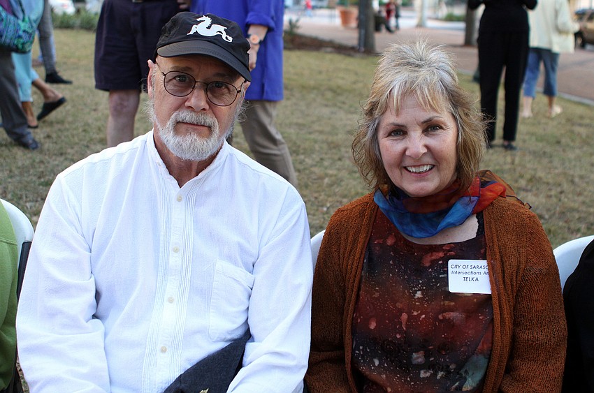 Dan Howachyn and Tekla sit in the front row listening to the jazz band Thursday evening at Selby Five Points Park. Tekla is the sculptor who created â€œArchesâ€ which is located on the corner of Palm Avenue and McAnsh Street.