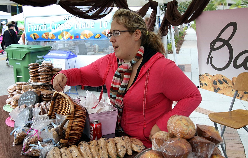 Christine Nordstrom, owner of Sift Bakehouse, talks to a customer about her wide variety of baked goods on Saturday, Jan. 22 at the farmers market.