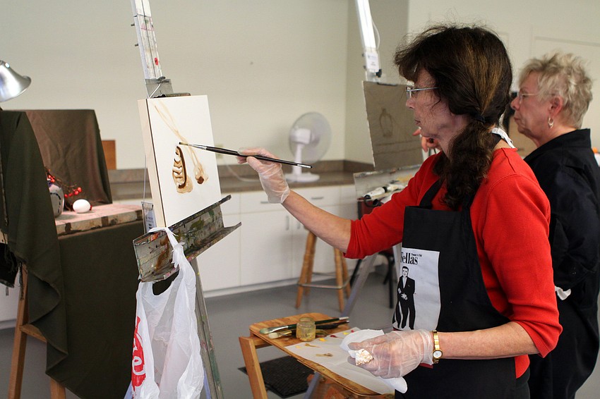Nancy Markle and Jean Rascher work on painting one of the many still lifes set up for the artists attending David Leffel's workshop at Longboat Key Center for the Arts.