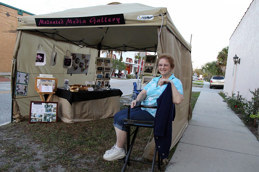 Maureen Ogilvie sits outside her tent at Rosemary District's Rosemary Rising.