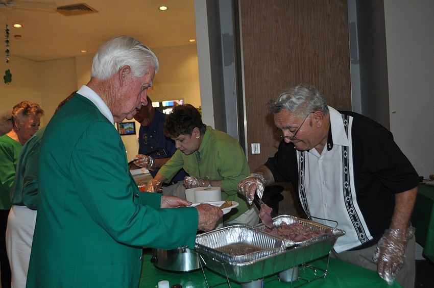 Dr. Joe Griffin is served a generous helping of corned beef by Bob Orlando.