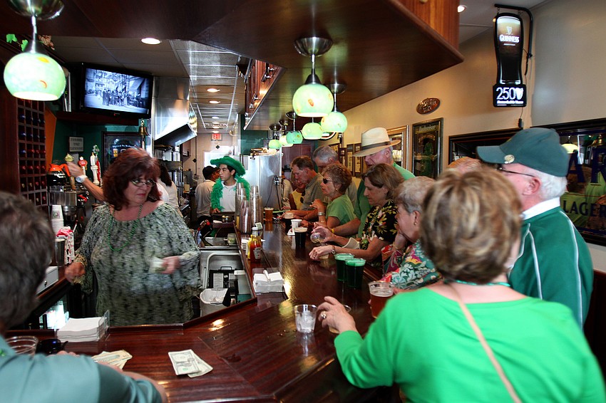 People order drinks at the bar inside Lynches Pub.