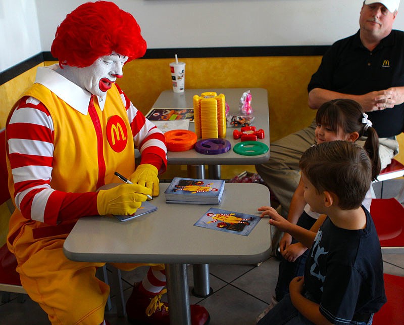 Ronald McDonald with James, 7, and Natalie, 4, Carrion.