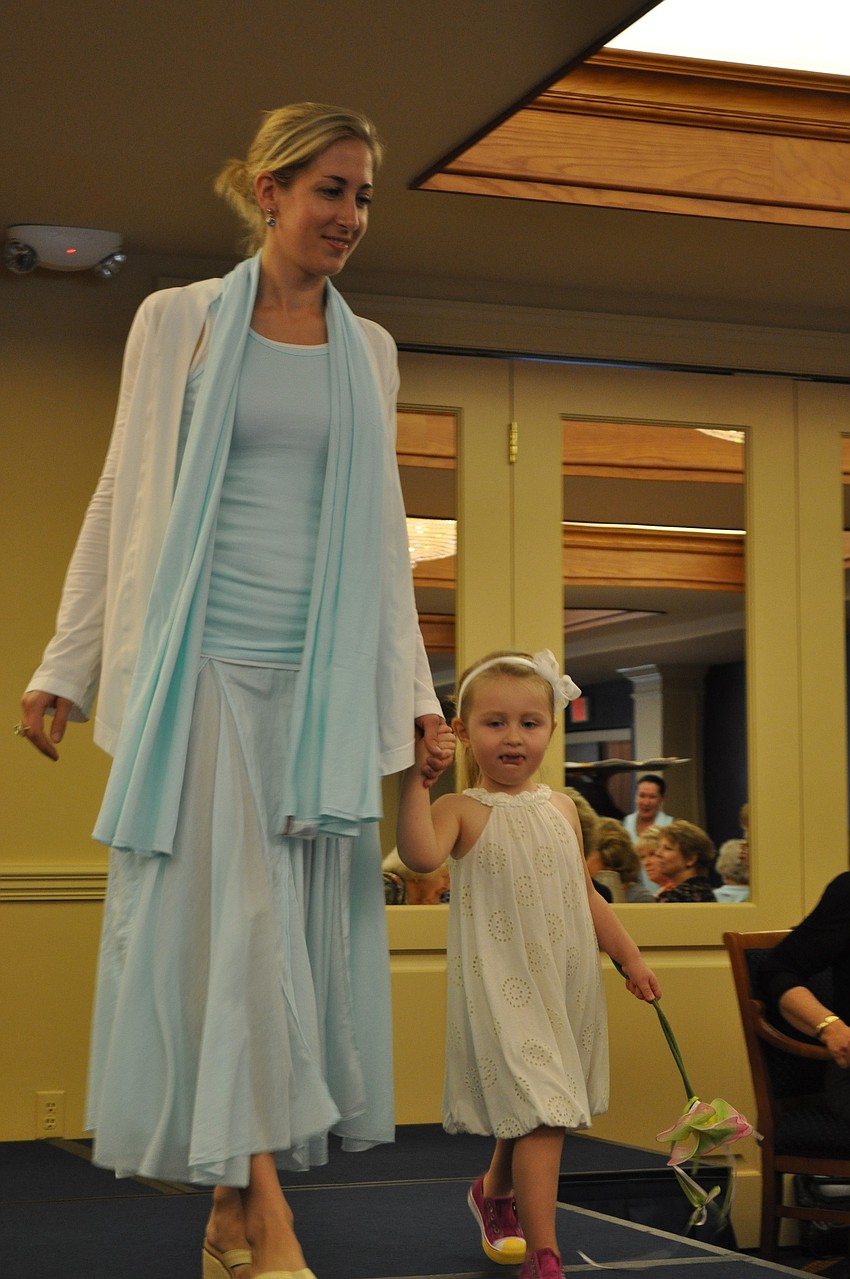 Rena Nietz and daughter, Lena, walk the runway hand in hand.