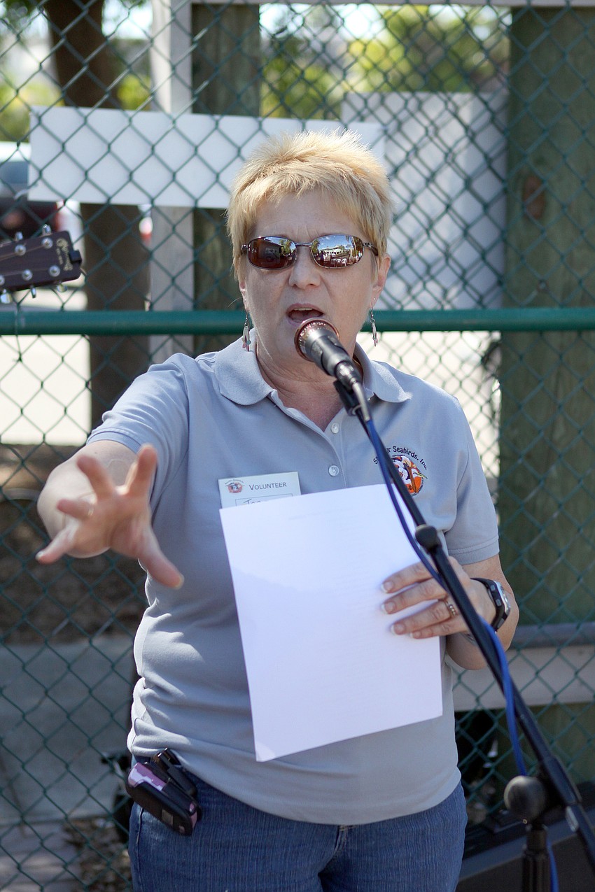 Joanne Lain, the volunteer coordinator for the birthday party, talks to the crowd attending the second birthday for Save Our Seabirds.