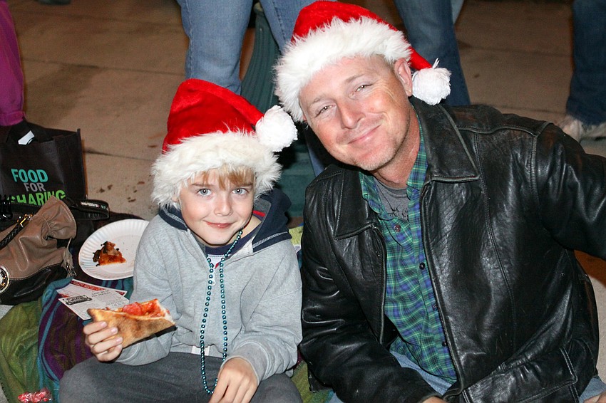 Jade and Hawk Holmes enjoy being together and watching the parade on Saturday, Dec. 4 on Main street.