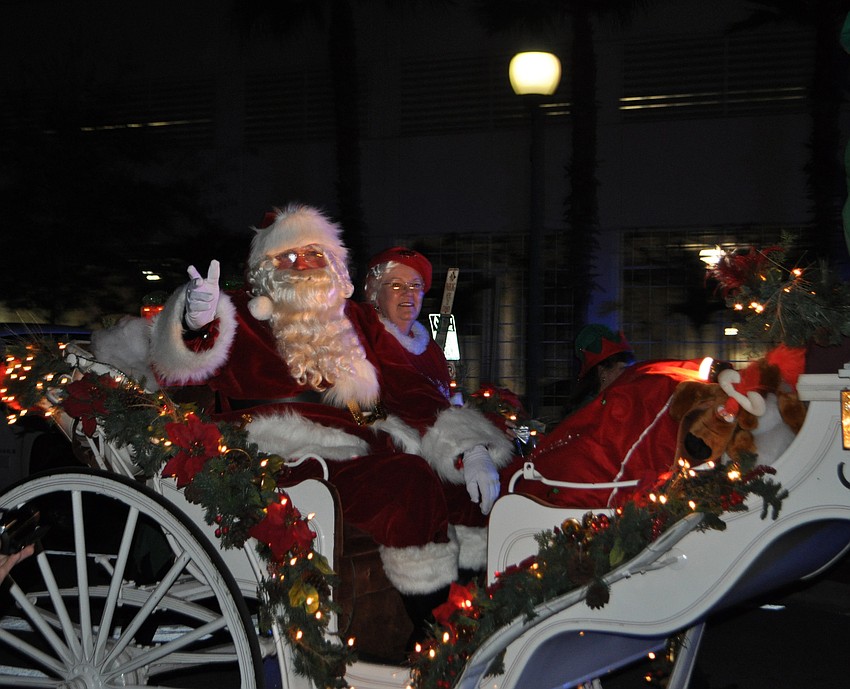 Santa Claus waves to the crowd.
