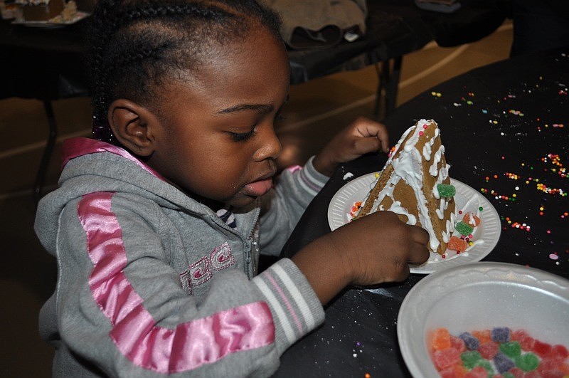 Danasia White, 2, got some help with her gingerbread house from her mom, Kawanna Brewer, not pictured.