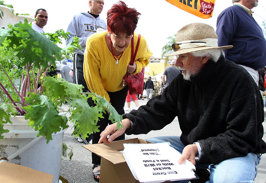 Lynn Glassman learns a little bit about the grow bucket that Carmel Monti sells on Saturday, Jan. 22 at the farmers market.