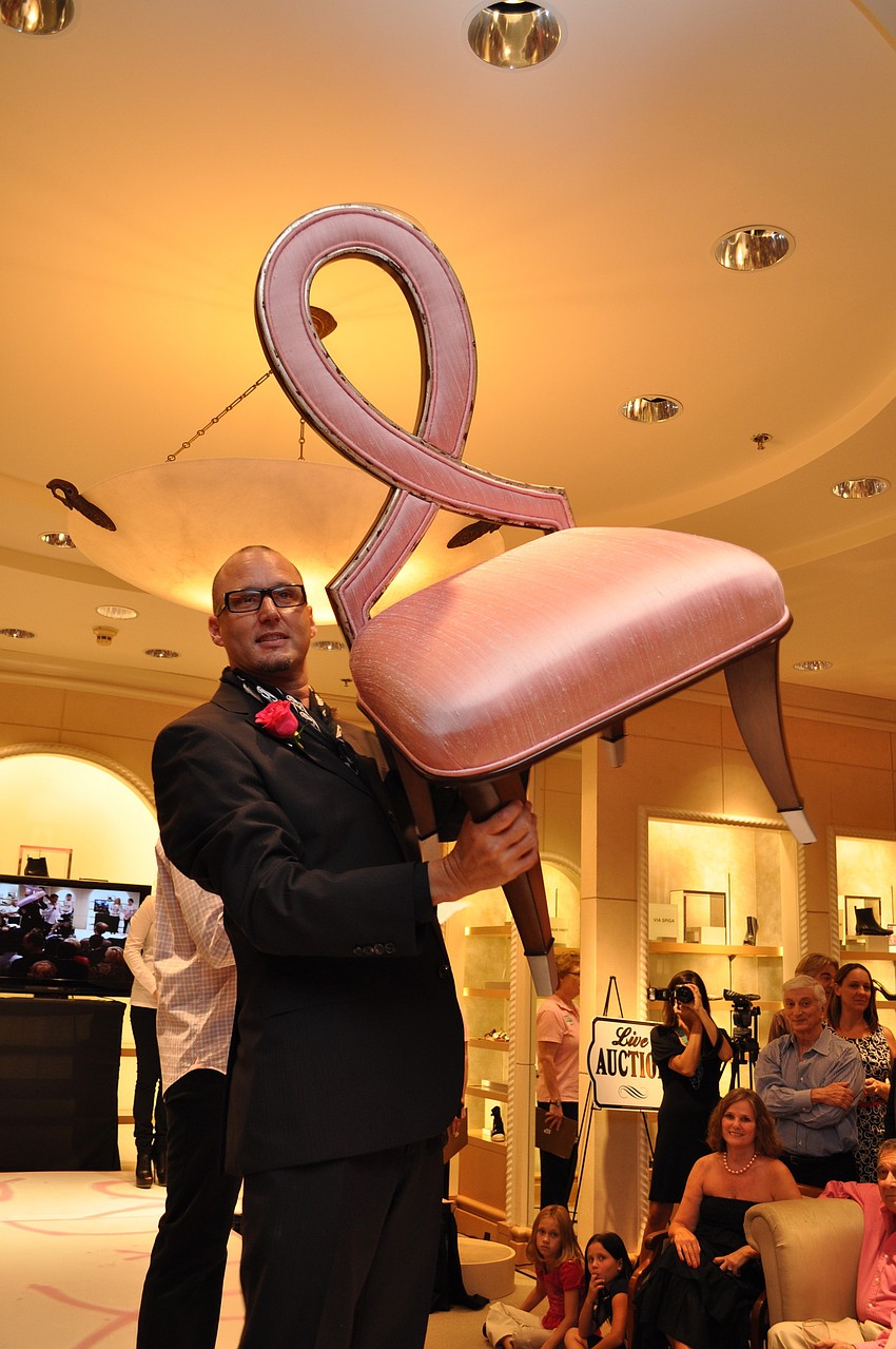 Robert Roubideaux shows off an auction item