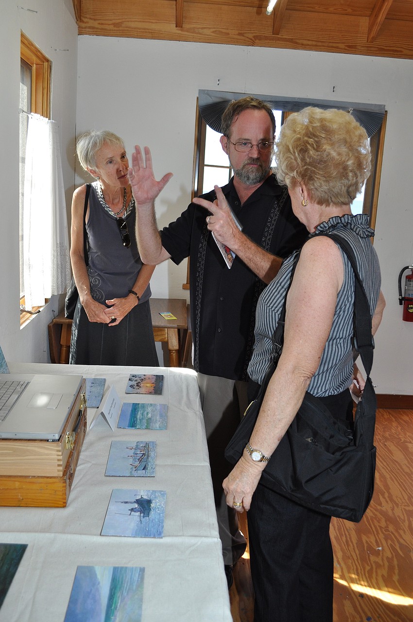 Dayle Adler and Susie Samp listen to painter Christopher Still