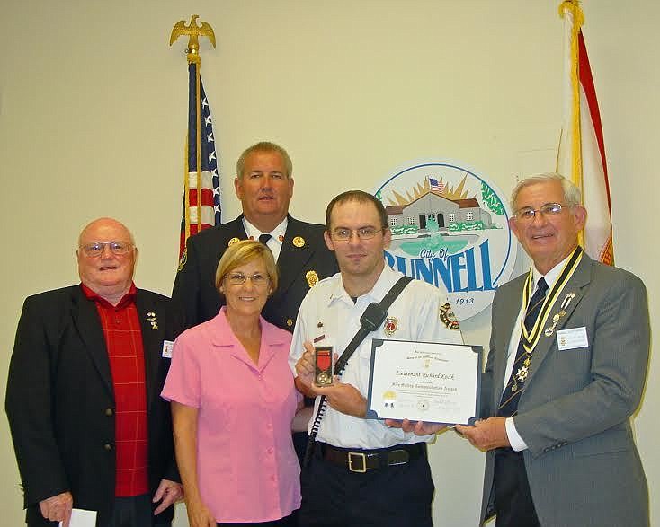 Lt. Richard Kocik received his award from Randall Morris, president of the Sons of the American Revolution Flagler Chapter, as David Kelsey, Mayor Catherine Robinson, and Fire Chief Derek Fraser look on. (Provided photo)