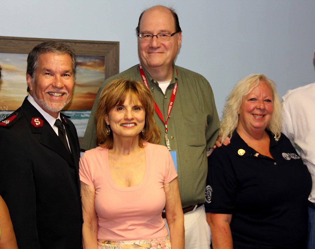 Major Stan Colbert, Joni Casillas, Tony Deobil, and Pamela Andrews pose for photos during the Open House for the new Salvation Army Office in Bunnell. (Photo by Jacque Estes)