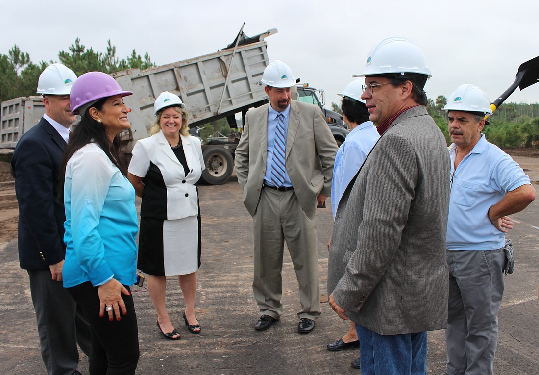 County Engineer Faith Alkhatib, left, updates Flagler Schools Superintendent Jacob Oliva, behind, and Lynette Shott, as well as County Administrator Craig Coffey and commissioners Barbara Revels, Nate McLaughlin and George Hanns.