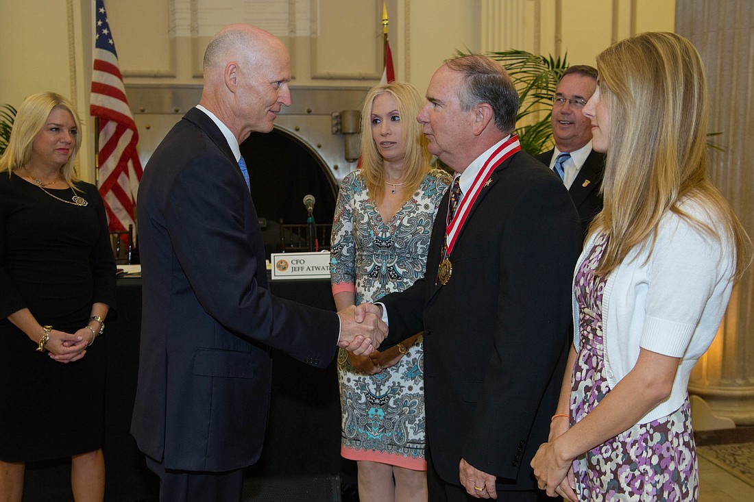 Gov. Rick Scott congratulates Rick Staly for 40 years of law enforcement service. Courtesy photo