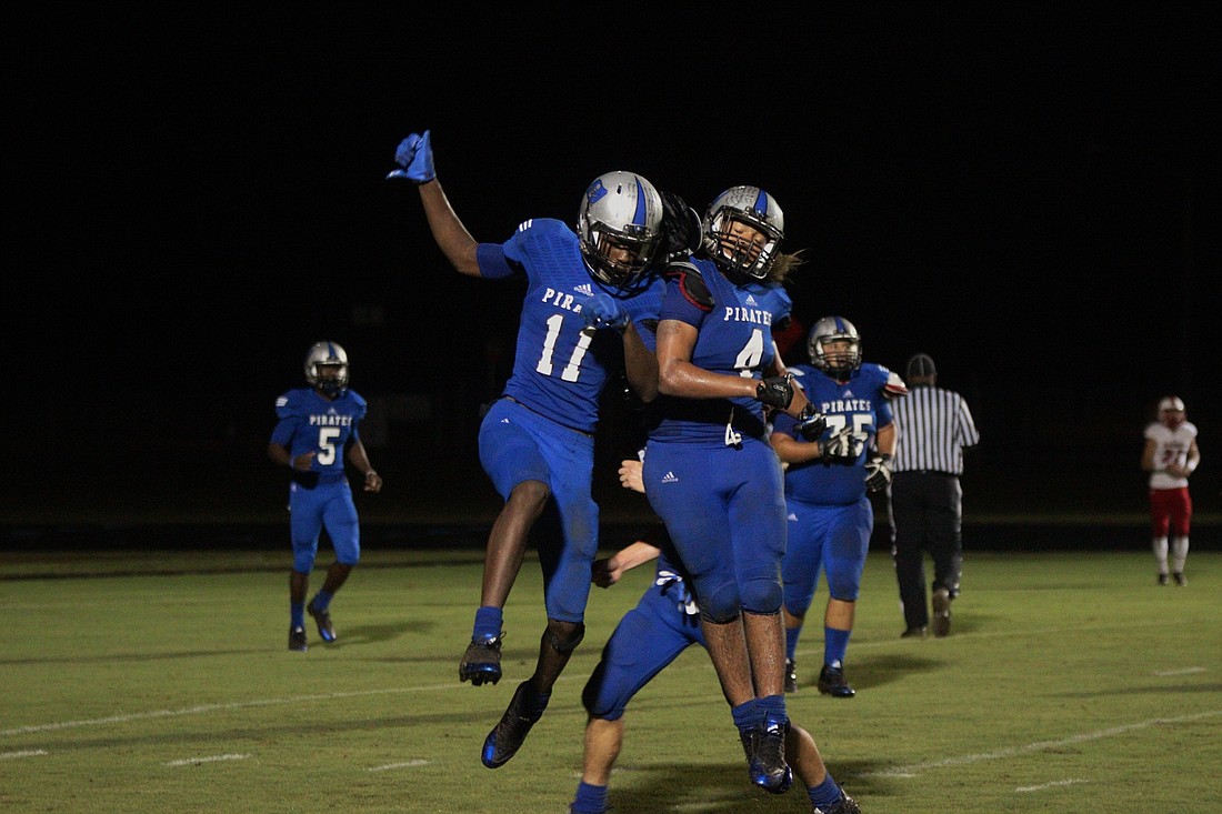 Daniel Dillard celebrates with Andre Bodison after he catches his 47-yard touchdown pass. Photo by Jeff Dawsey