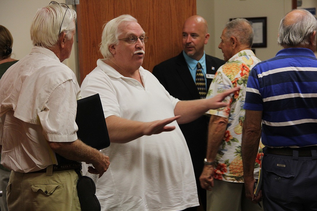 Doug Courtney, Belle Terre Swim and Racquet Club Advisory Committee president tells his group they didn't need to attend evening school board meeting. Photo Jacque Estes