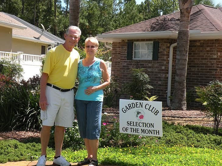 Morrie and Elaine Baker stand in front of their home which was recently honored by the Garden Club of Palm Coast. Courtesy photo.
