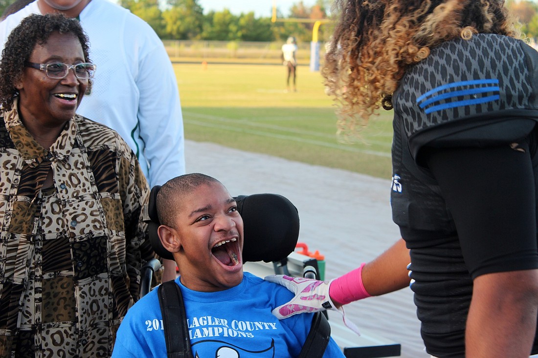 Michael Bailey, a student with special needs at Matanzas, greets his friend, Daniel Dillard, before a recent game.