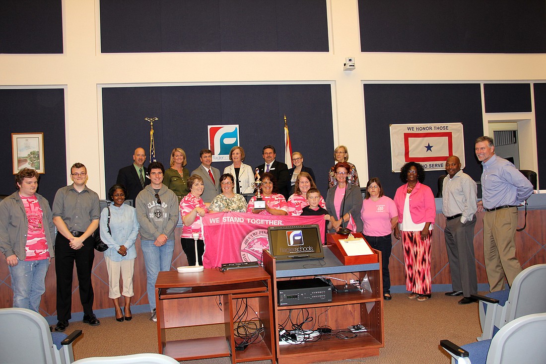 Members of the Belle Terre Elementary School Fajardo Team accept the first place trophy for the 2015 Florida Hospital Flagler Pink Army 5K at the Nov. 17 School Board meeting. Photo Jacque Estes