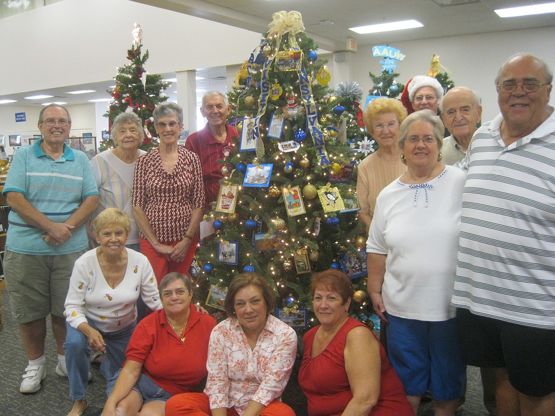 Members of the Pennsylvania Social Club gather around their decorated tree at the Flagler County Public Library. Courtesy photo