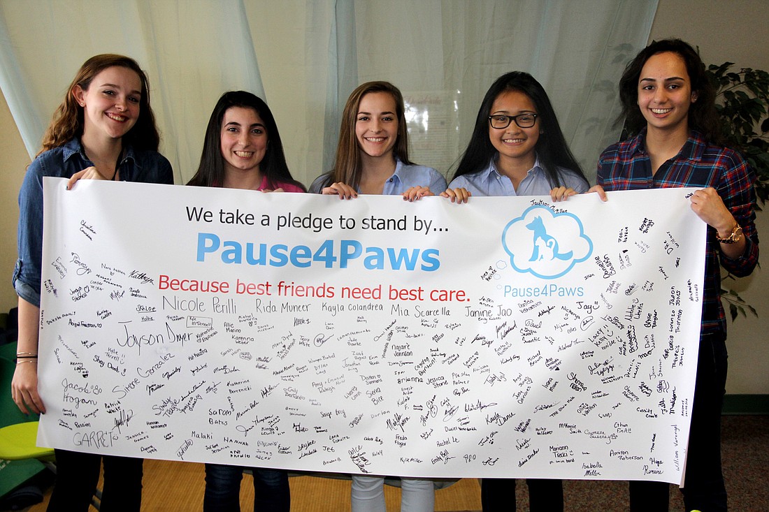 The FPC Pause4Paws team, Kayla Colandrea, Mia Scarcella, Nicole Perilli,  Janine Jao,  and Rida Muneer hold their pledge banner. Photo Jacque Estes