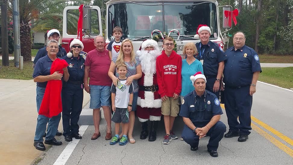 Santa Claus and the Palm Coast Volunteer firefighters, visited the Clayton family on Sunday, Dec. 13. Courtesy photo
