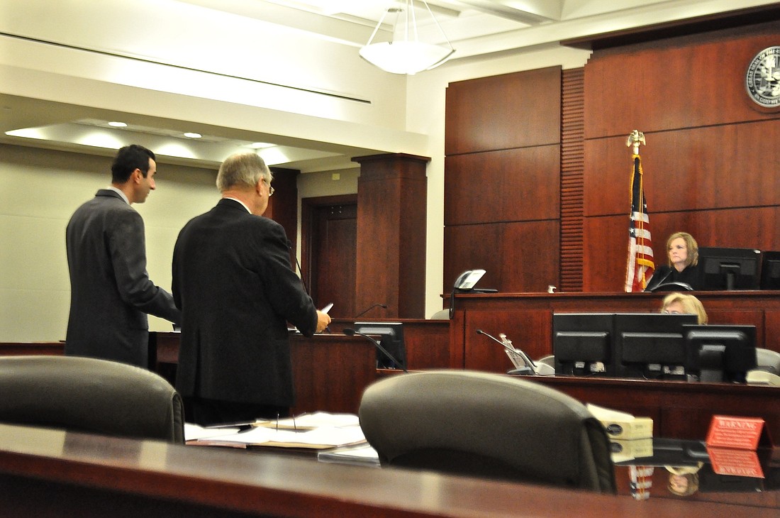 Assistant State Attorney Jason Lewis and defense attorney Joerg Jaeger discuss the Kimberle Weeks case before Judge Margaret Hudson. (Photo by Jonathan Simmons.)