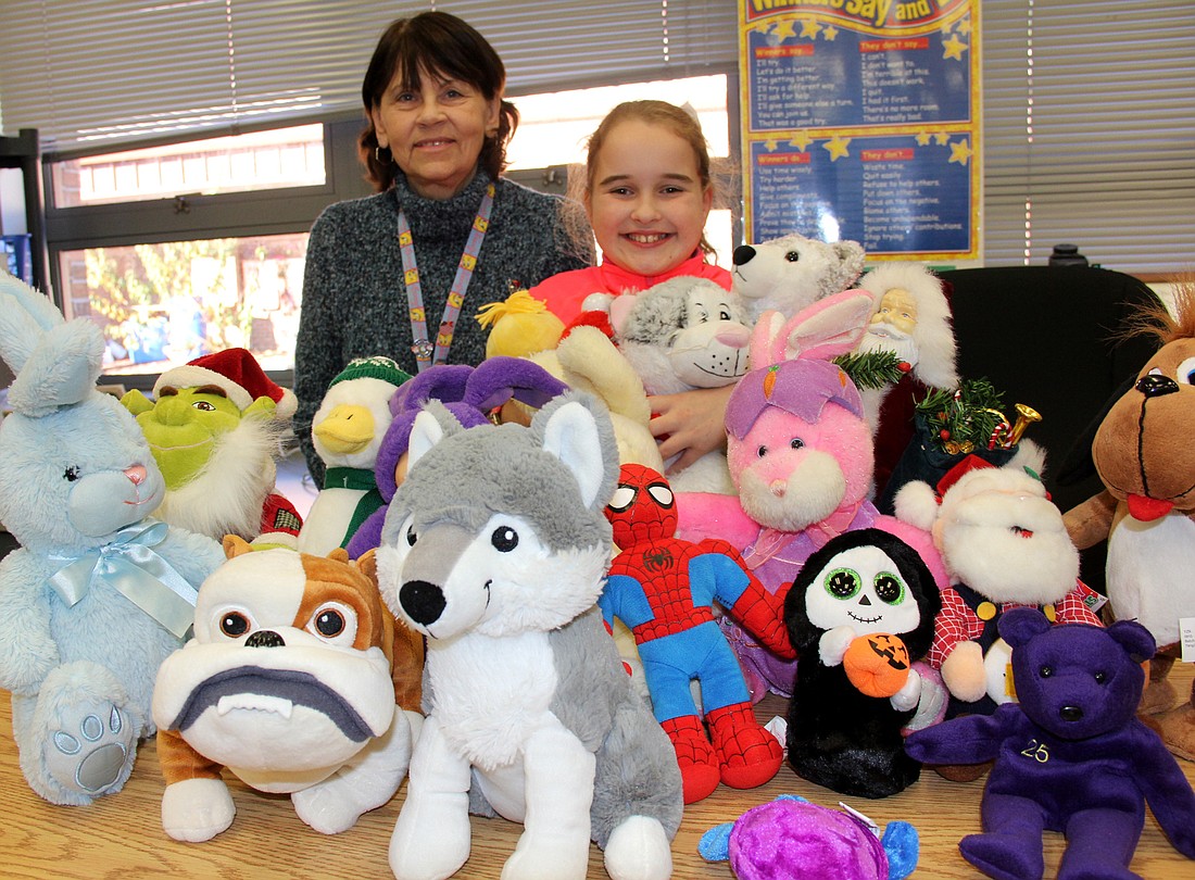 Lauren Schiller and Hailey Sands are surruonded by "a few" of the stuffed animals that have been donated for this year's Relay for Life in Central Park, at Town Center. Photo Jacque Estes