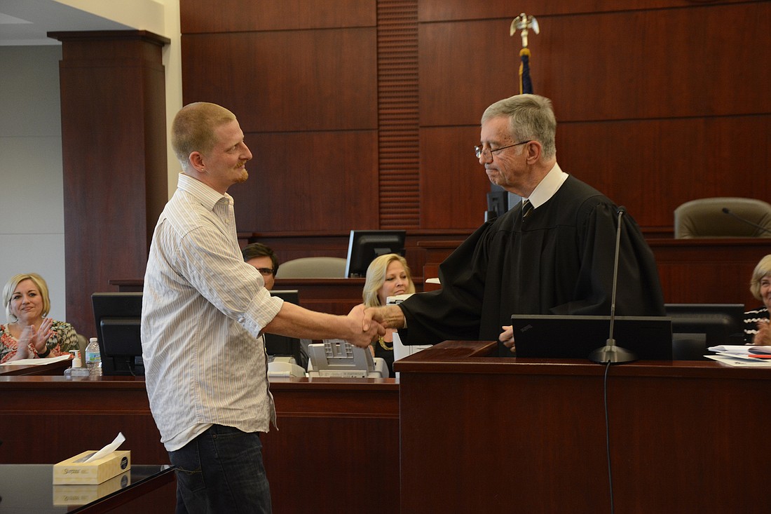 Circuit Judge David Walsh congratulates Drug Court graduate Robert Ward. (Photo by Anastasia Pagello.)