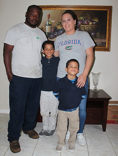 Charlie Washington, his wife, Michal, and their two sons, Kaevon and Elijah.