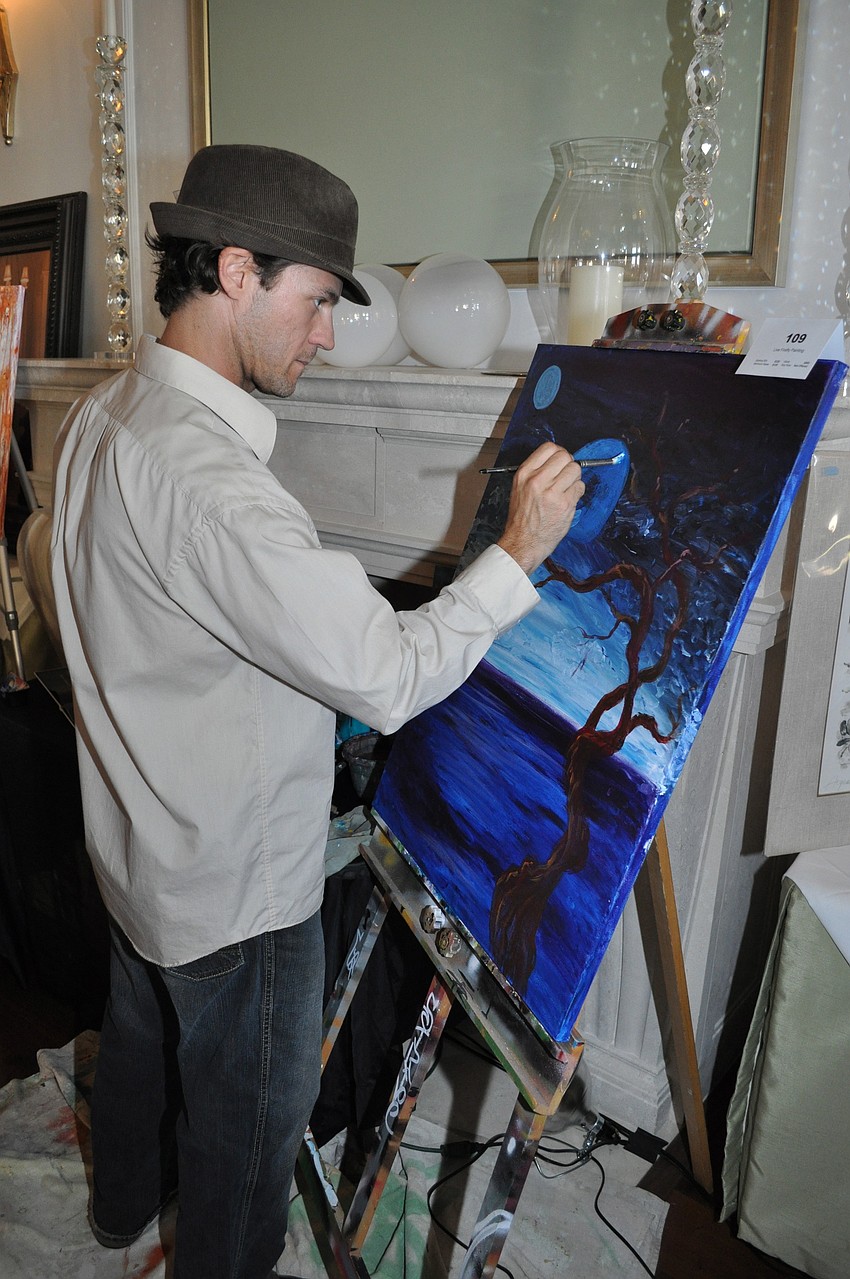 Artist Cheeta Chad Ruis painting for the live auction
