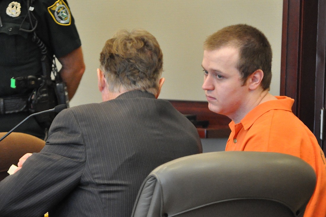 James McDevitt speaks with attorney Michael Lambert during his sentencing hearing May 29. (Photo by Jonathan Simmons.)