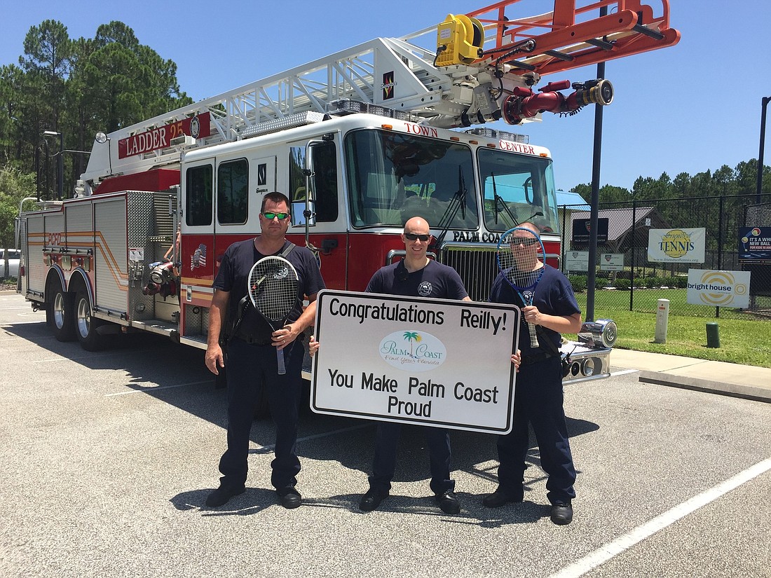 Palm Coast firefighters hold up congratulatory sign for Reilly Opelka.