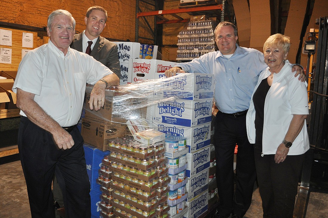 Lakewood Ranch Rotary Club members Joe Weber, Chris Perkins, John Freeman and Laurie Hagberg toured The Food Bank warehouse the day the donation was received.