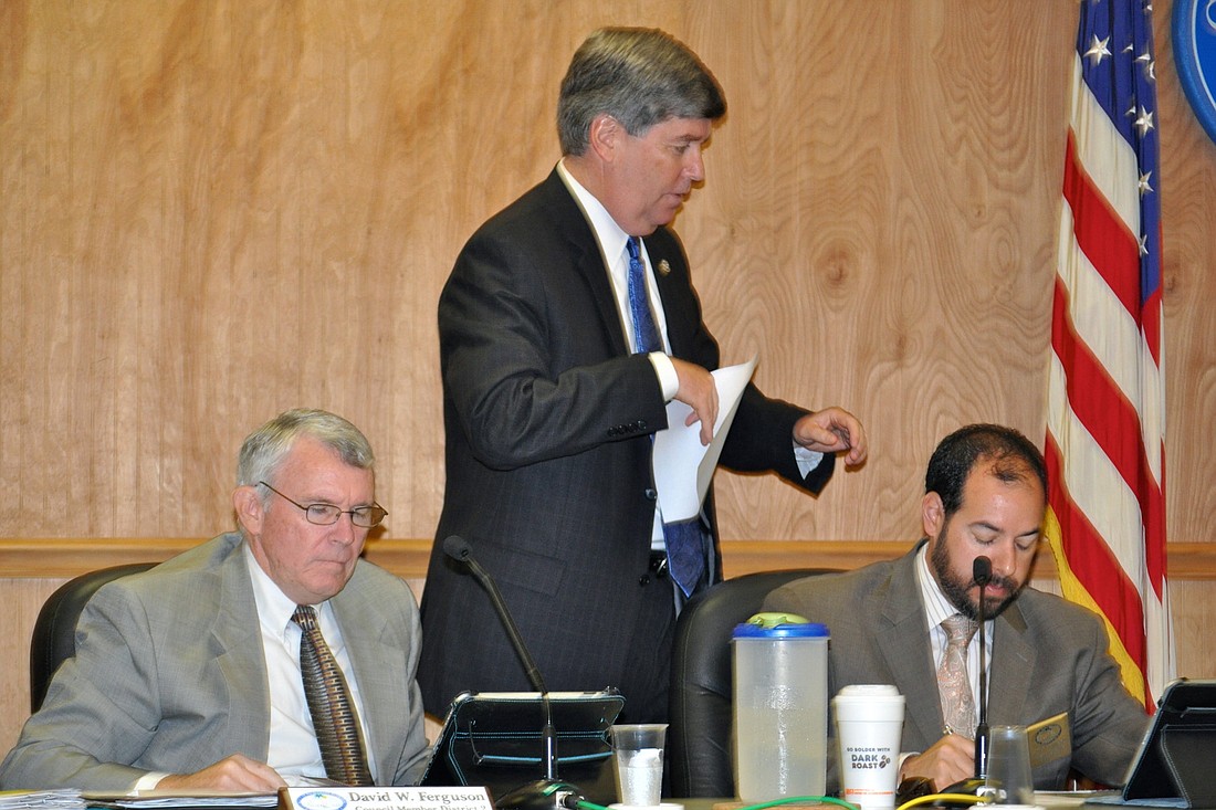 City Manager Jim Landon (center) collects Councilman David Ferguson's (left) and Councilman Jason DeLorenzo's nominations for the Beautification and Environmental Advisory Committee, April 15. (Photo by Jonathan Simmons)