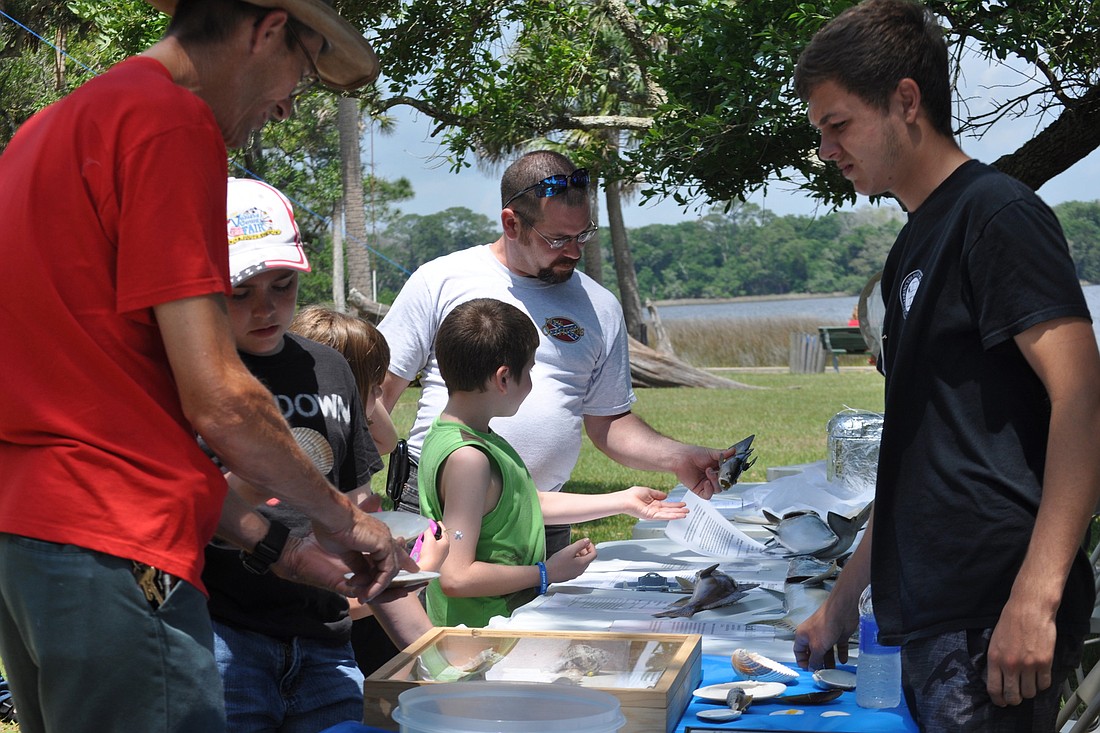 Legacy program student Johnny Dougherty shows off fish he studied during a biological survey.