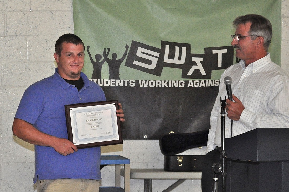 Richard Jarosz, left, graduated form Open Door Sunday, Nov. 16, and was presented with a certificate and a new study Bible by the Rev. Charles Silano, right. (Photo by Jonathan Simmons.)