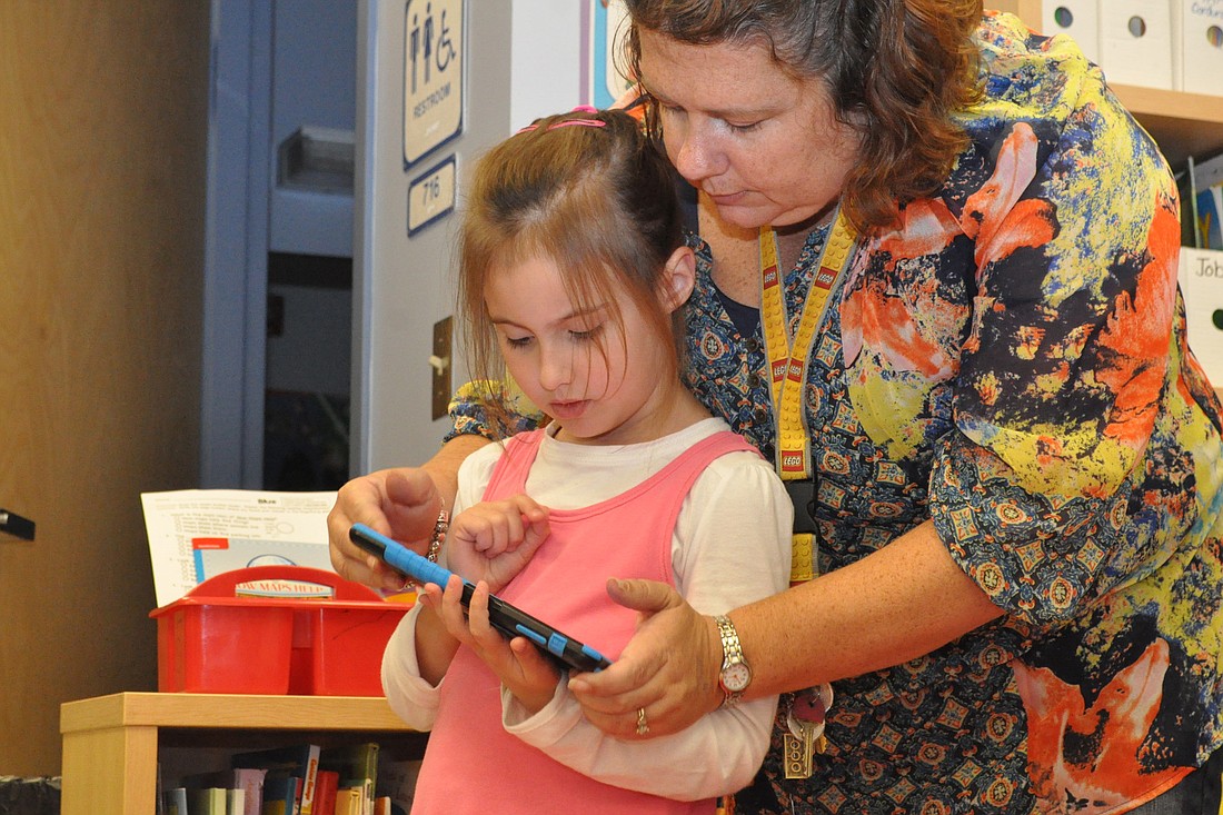 Belle Terre Elementary School teacher Teresa Phillips helps student Alina Morse with a Sphero coding project. (Photo by Jonathan Simmons.)