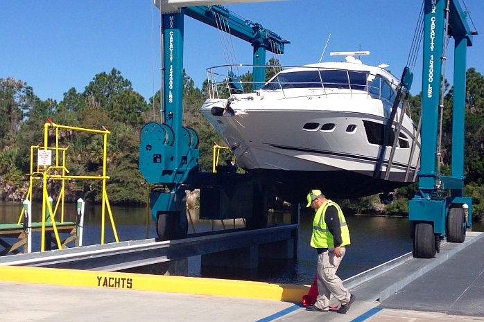 A Sea Ray Boats worker helps lower a yacht at the company's facility off Roberts Road. (File photo by Jonathan Simmons.)