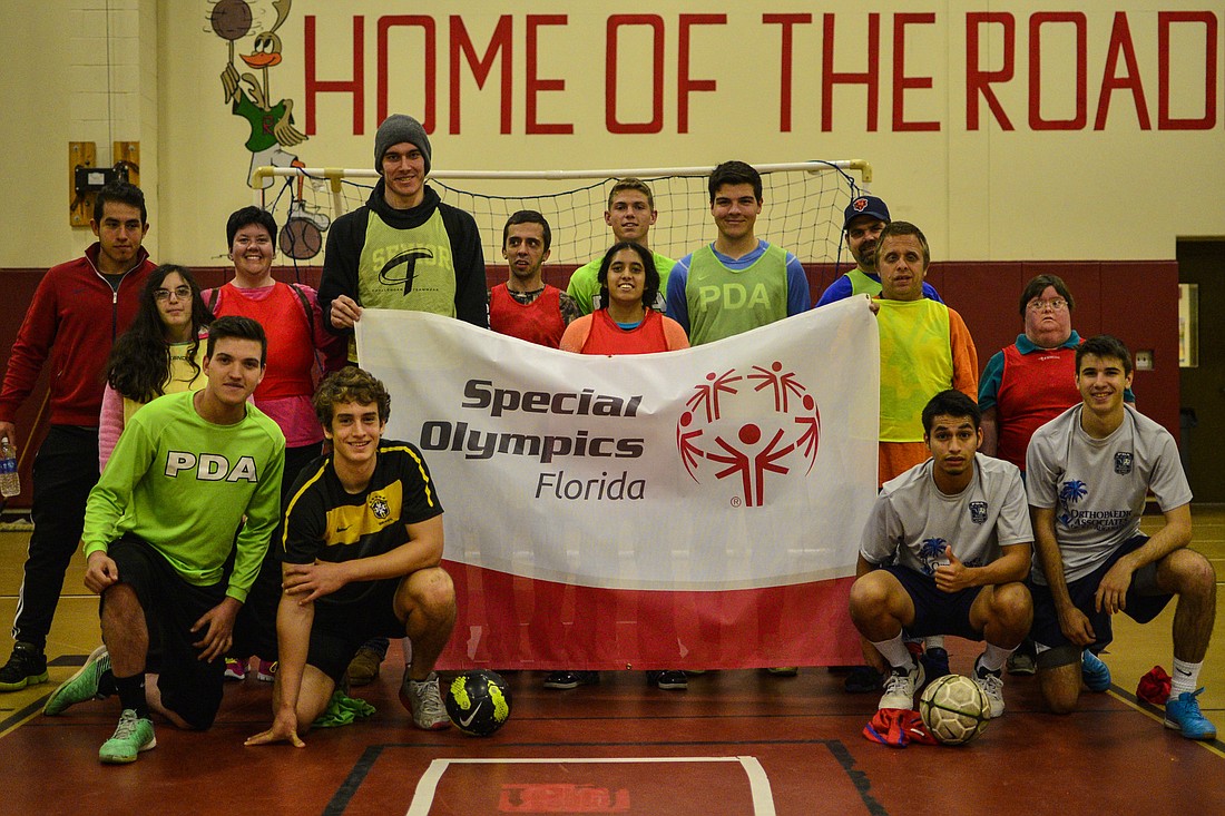 PDA soccer players and Special Olympic athletes gather for the opening ceremony.