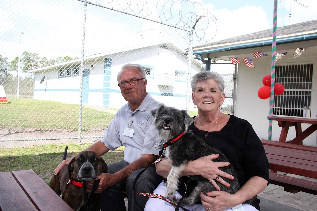 John and Carol Strigle sow off their new dogs, Finn and Vincy, after a graduation program March 12, at Tomoka Correctional Institute.