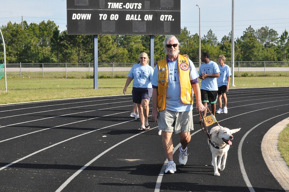 Lions member Wayne Gile and his yellow Labrador, Destinee, led the Lions ClubÃ¢‚¬„¢s annual Walk for the Blind at Matanzas High School April 11. (Photo by Jonathan Simmons.)