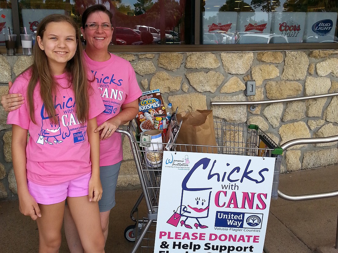 Leslie Van Brink and daughter, Cassidy collect food at the 2014 drive.