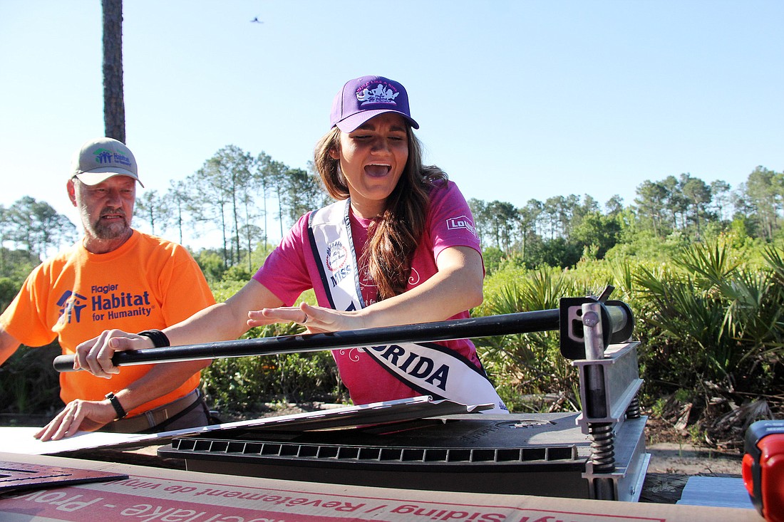 Miss Florida US 2015 Kristie OÃ¢‚¬„¢Brien cuts siding at the Flagler Habitat Women Build Saturday, May 2.